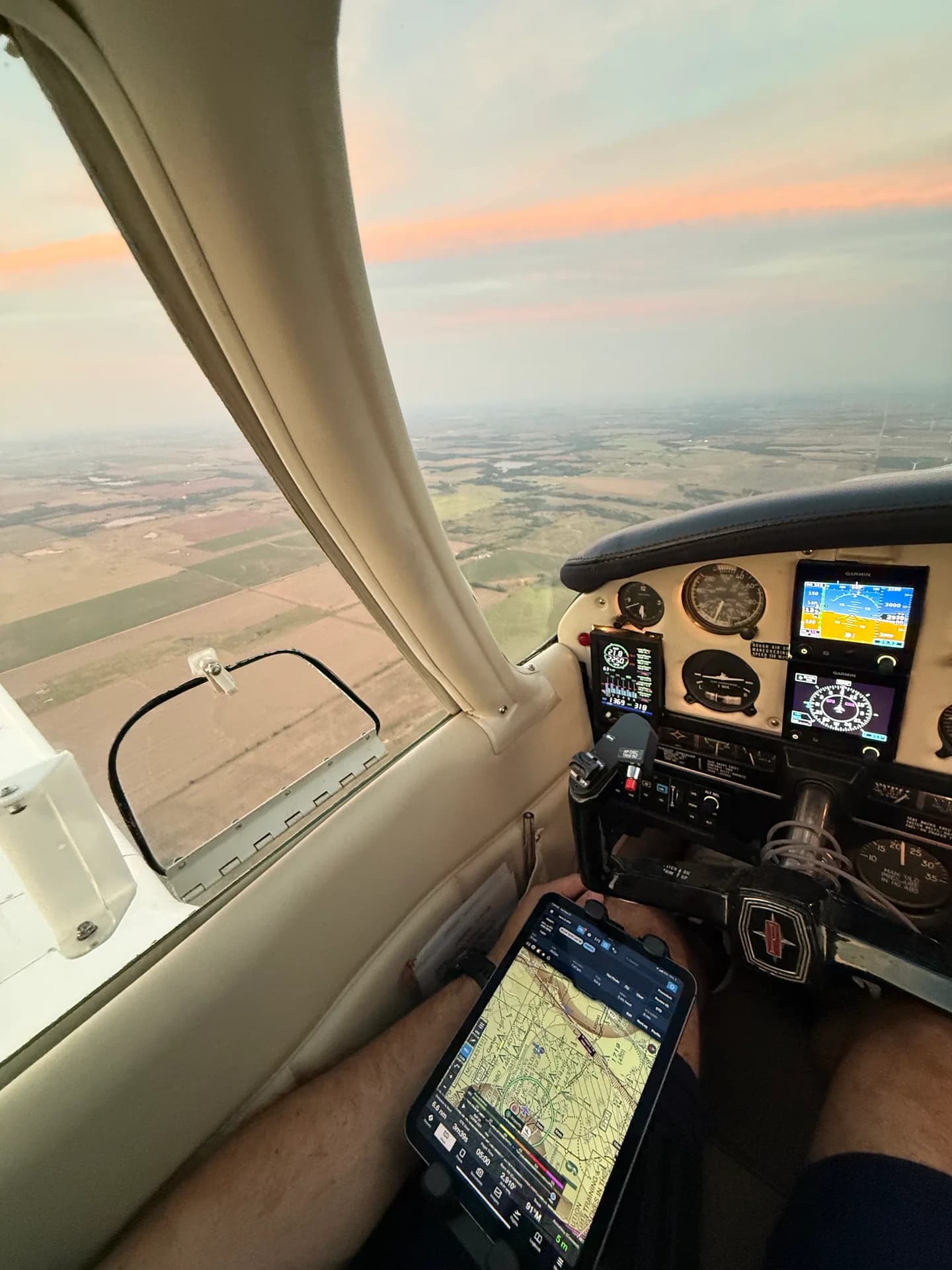 Seated cockpit view showing the FlightPro leg-strap iPad holder on the pilot’s thigh