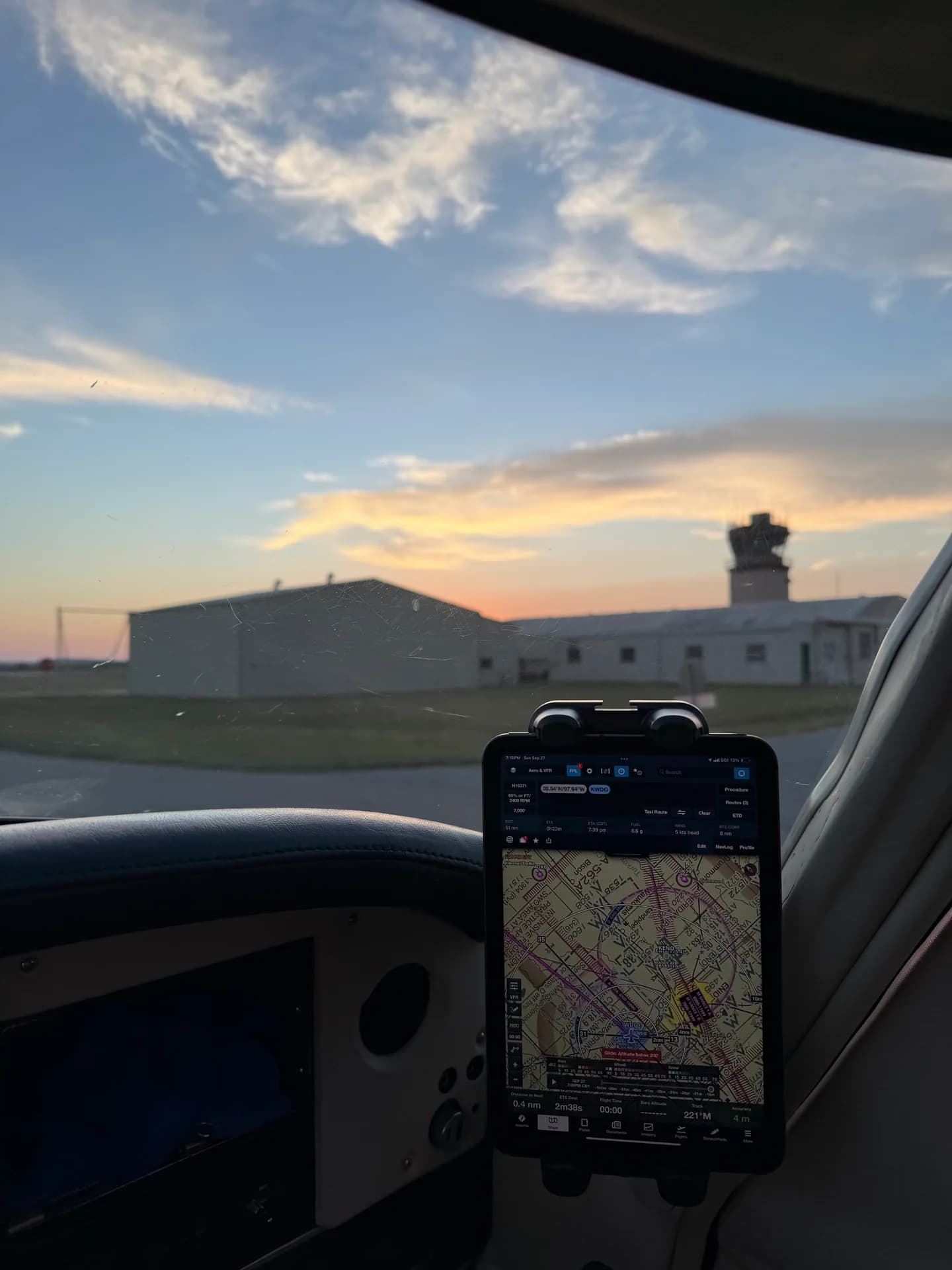 FlightPro iPad holder photographed in the cockpit on the ground, with airport buildings outside